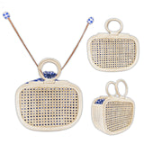 A collection of three woven handbags crafted from rattan, displayed against a neutral background. The handbags feature blue and white patterns, with one having a handle, another a shoulder strap, and the third appearing as a clutch without handles or straps.