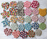 A set of four handcrafted blue star felt coasters rests on a light-colored marble surface. Each star-shaped coaster is formed from hand-stitched blue and white felt balls, highlighting its artisanal craftsmanship. The varying textures of these felted coasters create a cozy and inviting appeal.