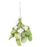 A felt mistletoe sprig ornament is suspended against a plain white background. It features tie-dye green felt leaves in various shades and shapes, showcasing their textured surfaces. Several small, round white felt berries are nestled among the leaves, creating a striking contrast. A jute string, looped at the top, is wrapped around the sprig, forming a charming bow for hanging.