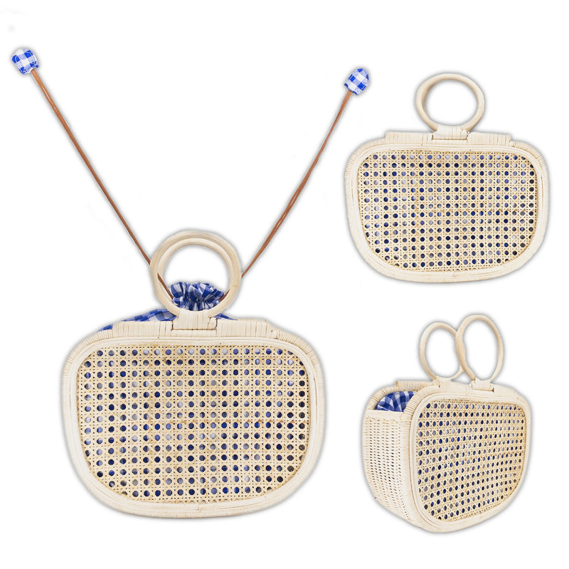 A collection of three woven handbags crafted from rattan, displayed against a neutral background. The handbags feature blue and white patterns, with one having a handle, another a shoulder strap, and the third appearing as a clutch without handles or straps.