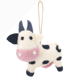 A single felt cow Christmas ornament, part of the Farmland Animals set, is displayed against a crisp white backdrop. This charming handcrafted felt ornament features a creamy white body with black spots, a soft pink snout, small black eyes, and gray felt horns. A jute string is attached for easy hanging, perfect for a Christmas tree.