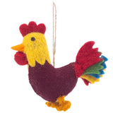 A single handcrafted rooster felt Christmas ornament, from the Farmland Animals set, is presented against a stark white background. This vibrant rooster features a bright yellow head and neck with a red cockscomb and wattle. Its body is deep burgundy, complemented by yellow feet and a multicolored tail of red, green, yellow, and blue felt layers. A jute string is attached, ready for hanging.