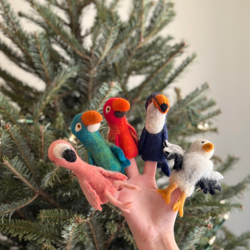 A hand holds five colorful wool felt finger puppets designed as various birds, showcasing unique features like different colors, patterns, and textures. The soft and plush texture of the wool felt is evident in each puppet. This set of handmade felt finger puppets is perfect for imaginative play.