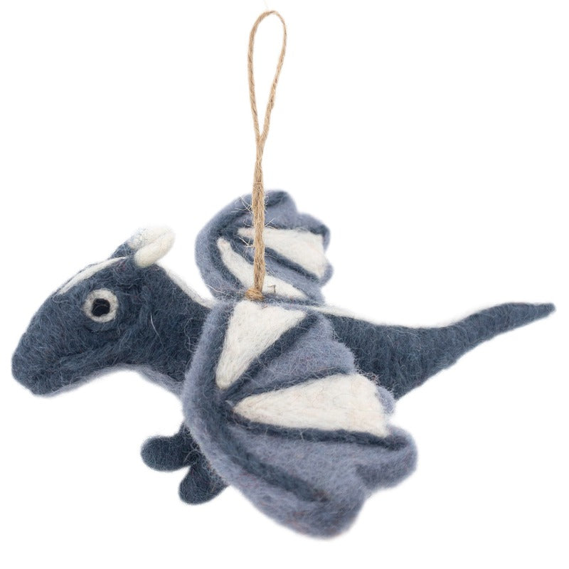 A needle-felted flying dragon ornament is suspended by a jute string against a stark white background. This whimsical wool felt dragon features a blue body with contrasting white wings and horn tips, and small beady eyes.