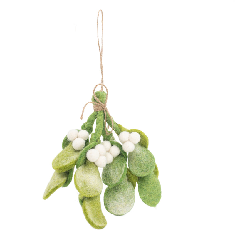 A felt mistletoe sprig ornament is suspended against a plain white background. It features tie-dye green felt leaves in various shades and shapes, showcasing their textured surfaces. Several small, round white felt berries are nestled among the leaves, creating a striking contrast. A jute string, looped at the top, is wrapped around the sprig, forming a charming bow for hanging.