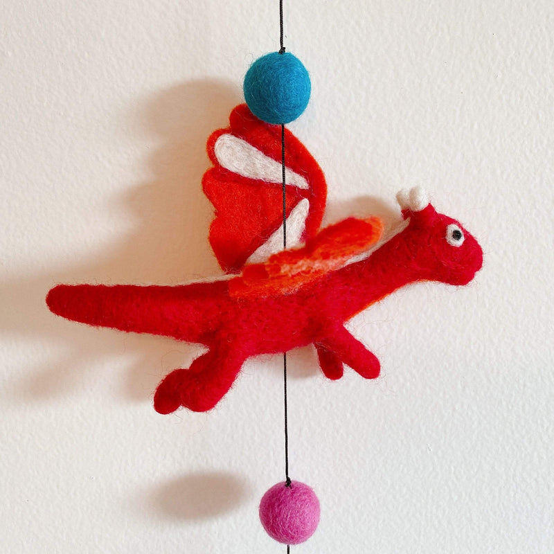 A vibrant Felt Dragon garland is displayed against a bright white background. This playful wool felt garland highlights a detailed red 3D pterosaur. It features white accents on its wings and horns, adding a whimsical touch.